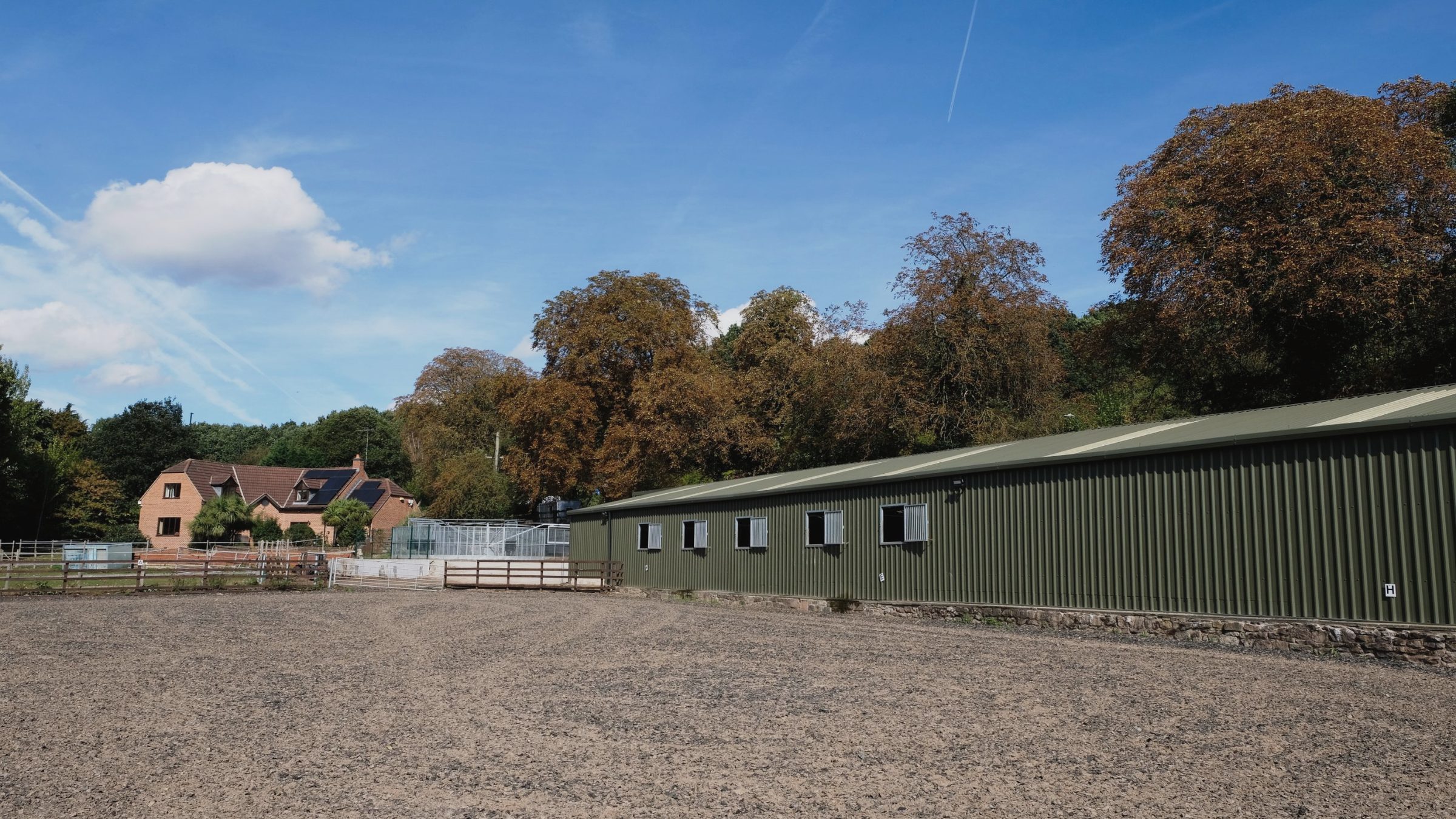 The floodlit outdoor school and stable block at Howarth Livery