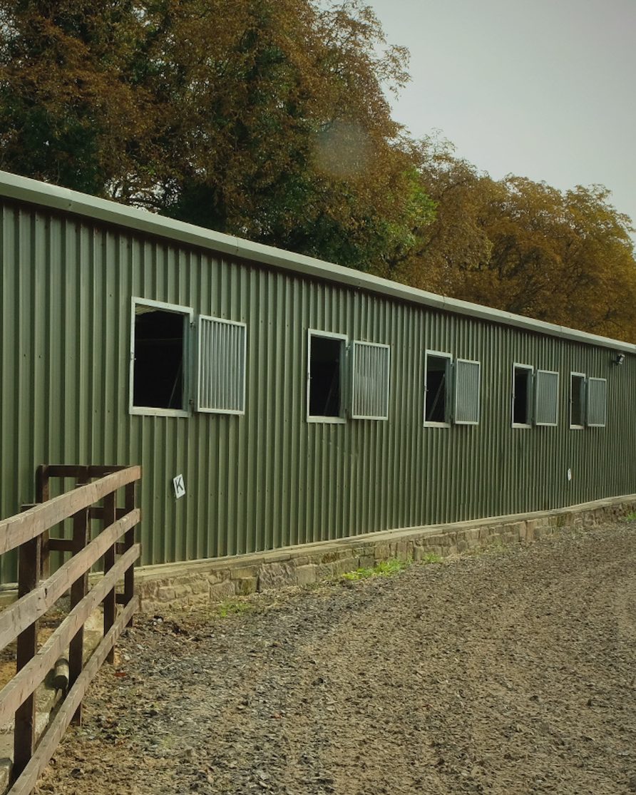 The outdoor school running alongside the green stable block