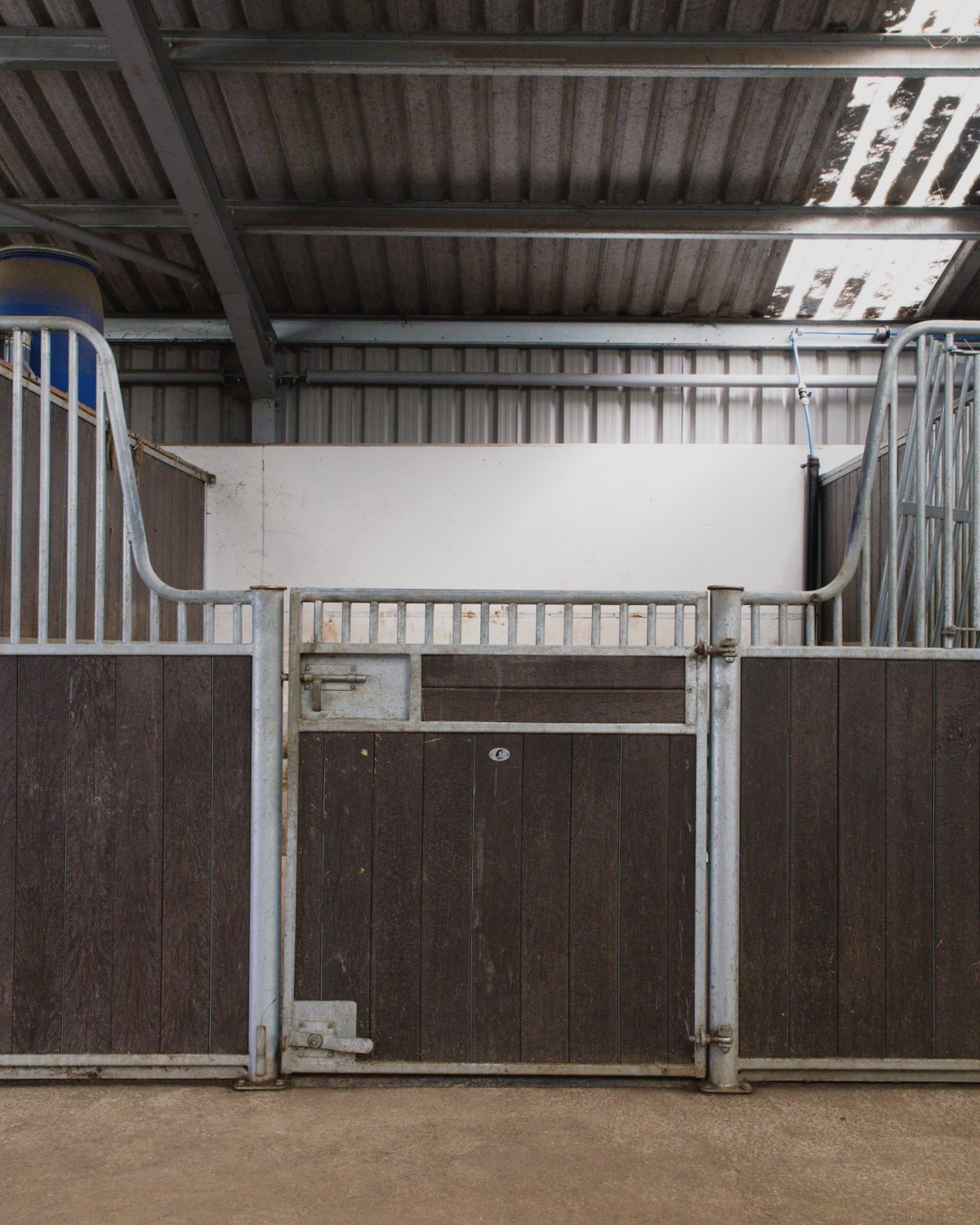 A stable door and galvanised partitions inside the stable barn